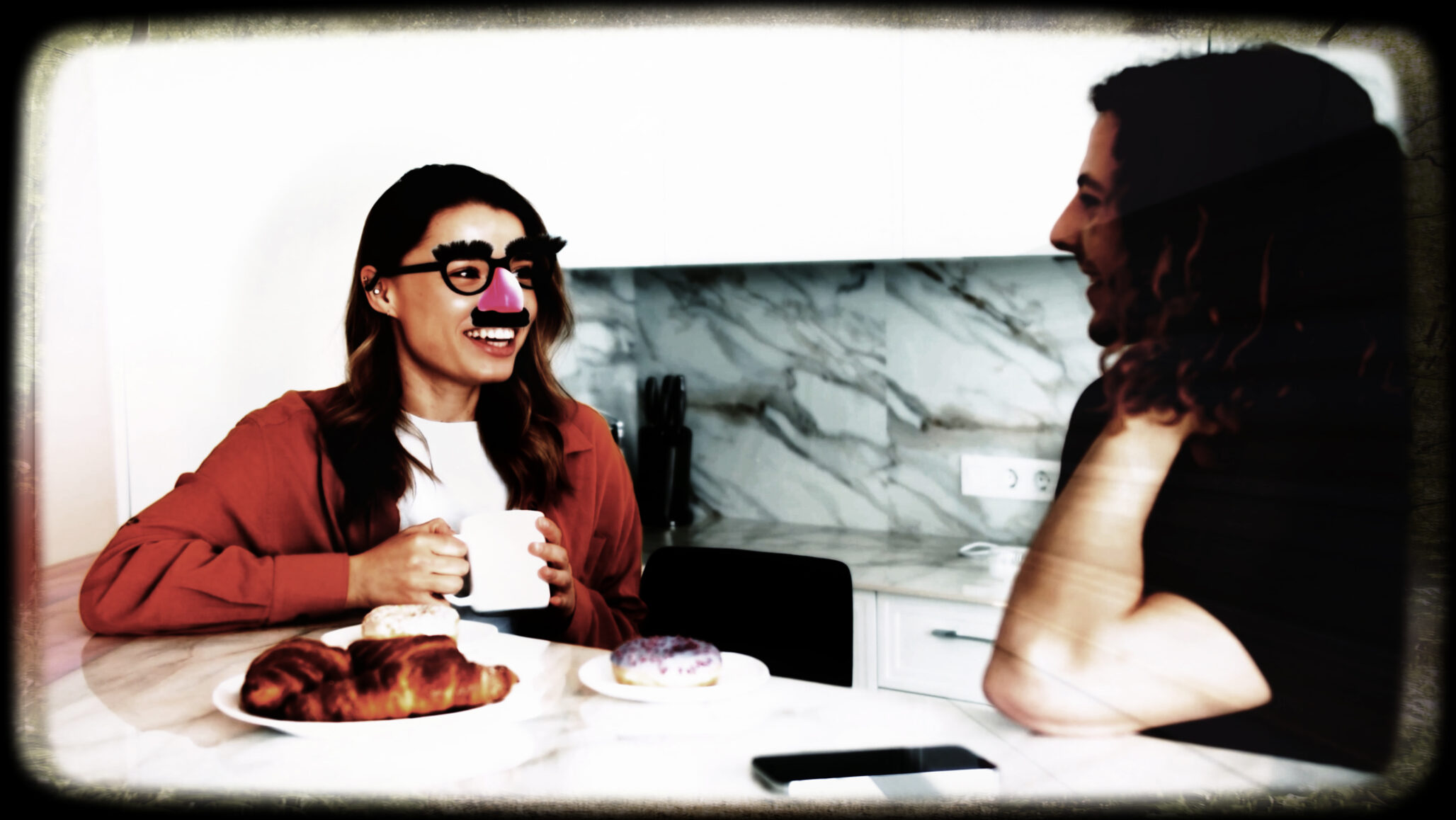 Link to Participant forty-eight's private page. A picture of a wife and a husband sitting a table in their kitchen. The morning takes an unexpected twist as Groucho Marx glasses and nose buddy playfully materialised on her face. A hallucination before the husband's eyes echoing her wit and humour: unusual yet endearing. A moment that remains vivid still - laughter through memory.